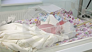 The newborn lies in the hospital.