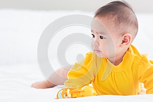 Newborn little baby prone on the bed at home