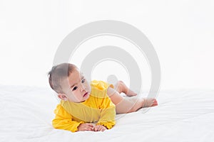 Newborn little baby prone on the bed at home