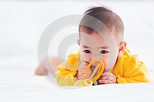 Newborn little baby prone on the bed at home