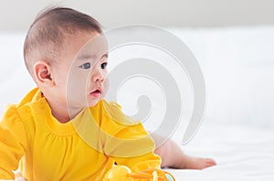 Newborn little baby prone on the bed at home