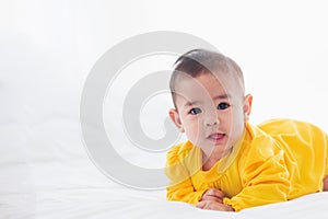 Newborn little baby prone on the bed at home