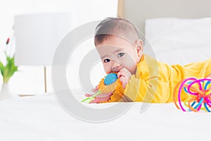 Newborn little baby prone on the bed at home