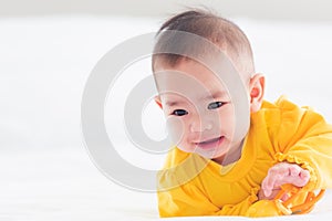 Newborn little baby prone on the bed at home