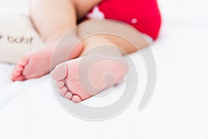 Newborn little baby sleeping on white bed at home