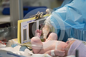 Newborn male baby having footprint made