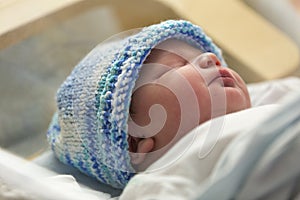 Newborn male baby sleeping after birth