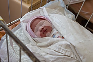 Newborn in maternity hospital,1 day of newborn baby`s birth in a maternity hospital