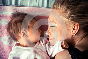 Newborn with mother looking at each other photo
