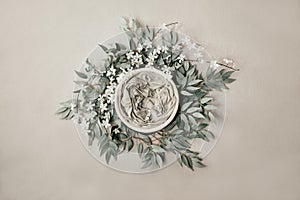 Newborn neutral background - cream bowl with eucalyprus leaves wreath on light grey background