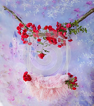 Newborn photo shoot swing on a purple floral background, decorated