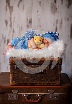 Newborn photography of 2 weeks old sleeping baby on soft fluffy
