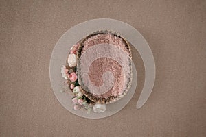 natural bowl with pink fur and floral arrangement. Newborn girl photography backdrop