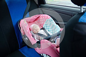 Newborn sleeping in car seat.Safety concept. Infant baby girl. secure driving with children. Baby care lifestyle