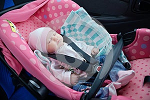 Newborn sleeping in car seat.Safety concept. Infant baby girl. secure driving with children. Baby care lifestyle. Cute baby