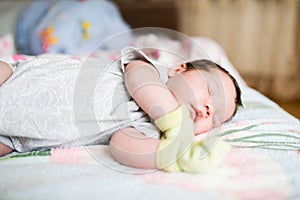 Newborn sleeping in mittens. Protect your hands from accidental scratches in your sleep. mother care