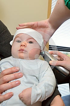 Newborn temperature check up with an ear thermometer