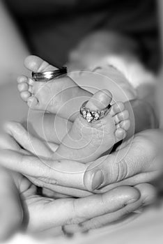 Newborn toes holding rings