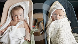 newborn twins baby swinging in a rocking chair. happy family kid dream concept. baby newborn brother and sister. child