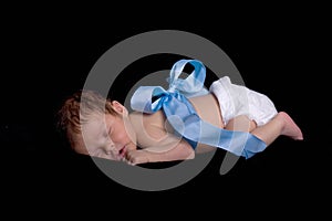 Newborn Wrapped up in Blue Ribbon with Bow