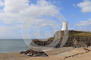 TÃÂµr Mawr lighthouse, on Ynys Llanddwyn on Anglesey, Wales, marks the western entrance to the Menai Strait. photo