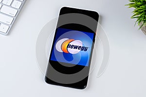 Newegg Mobile app logo on a smartphone screen.