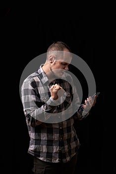 Newest technologies and development of society, communication between people. Young casual man reading something on his