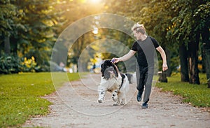 Newfoundland dog plays with man and woman