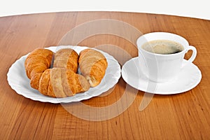 Newly-baked croissants and cup of coffee.