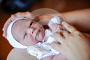 A newly born baby. The first days of life. Happy baby and mom at home. Feeding, wiping, hygienic procedures