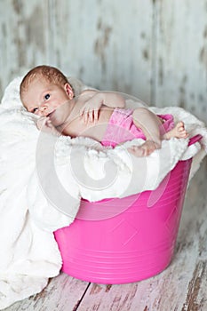 Newly born child in pink bucket