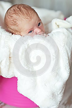 Newly born child in pink bucket