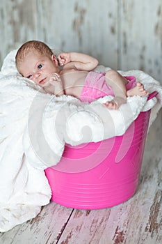 Newly born child in pink bucket