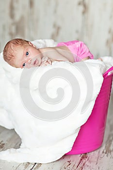 Newly born child in pink bucket