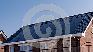 Newly build houses with solar panels attached on the roof against a sunny sky