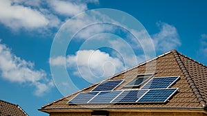 Newly build houses with solar panels attached on the roof against a sunny sky