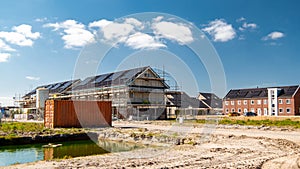 Newly build houses with solar panels attached on the roof against a sunny sky