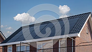 Newly build houses with solar panels attached on the roof against a sunny sky