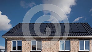 Newly build houses with solar panels attached on the roof against a sunny sky