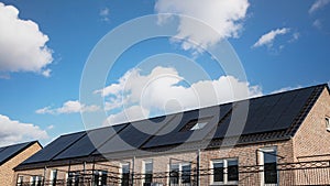 Newly build houses with solar panels attached on the roof against a sunny sky