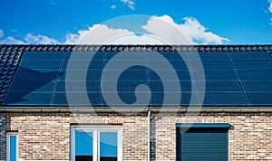 Newly build houses with solar panels attached on the roof against a sunny sky