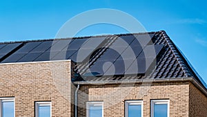 Newly build houses with solar panels attached on the roof against a sunny sky