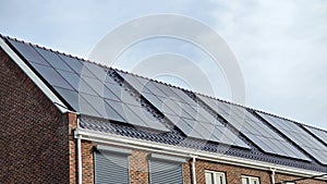 Newly build houses with solar panels attached on the roof against a sunny sky