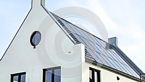 Newly build houses with solar panels attached on the roof against a sunny sky