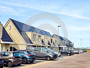 Newly build houses with solar panels attached on the roof against a sunny sky