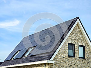 Newly build houses with solar panels attached on the roof against a sunny sky