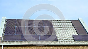 Newly build houses with solar panels attached on the roof against a sunny sky