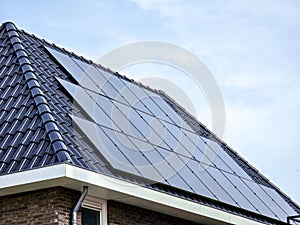 Newly build houses with solar panels attached on the roof against a sunny sky