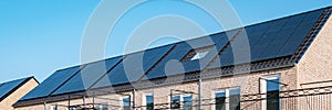 Newly build houses with solar panels attached on roof against a sunny sky Close up of solar pannel