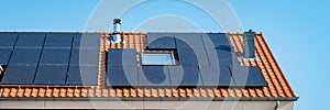 Newly build houses with solar panels attached on roof against a sunny sky Close up of solar pannel